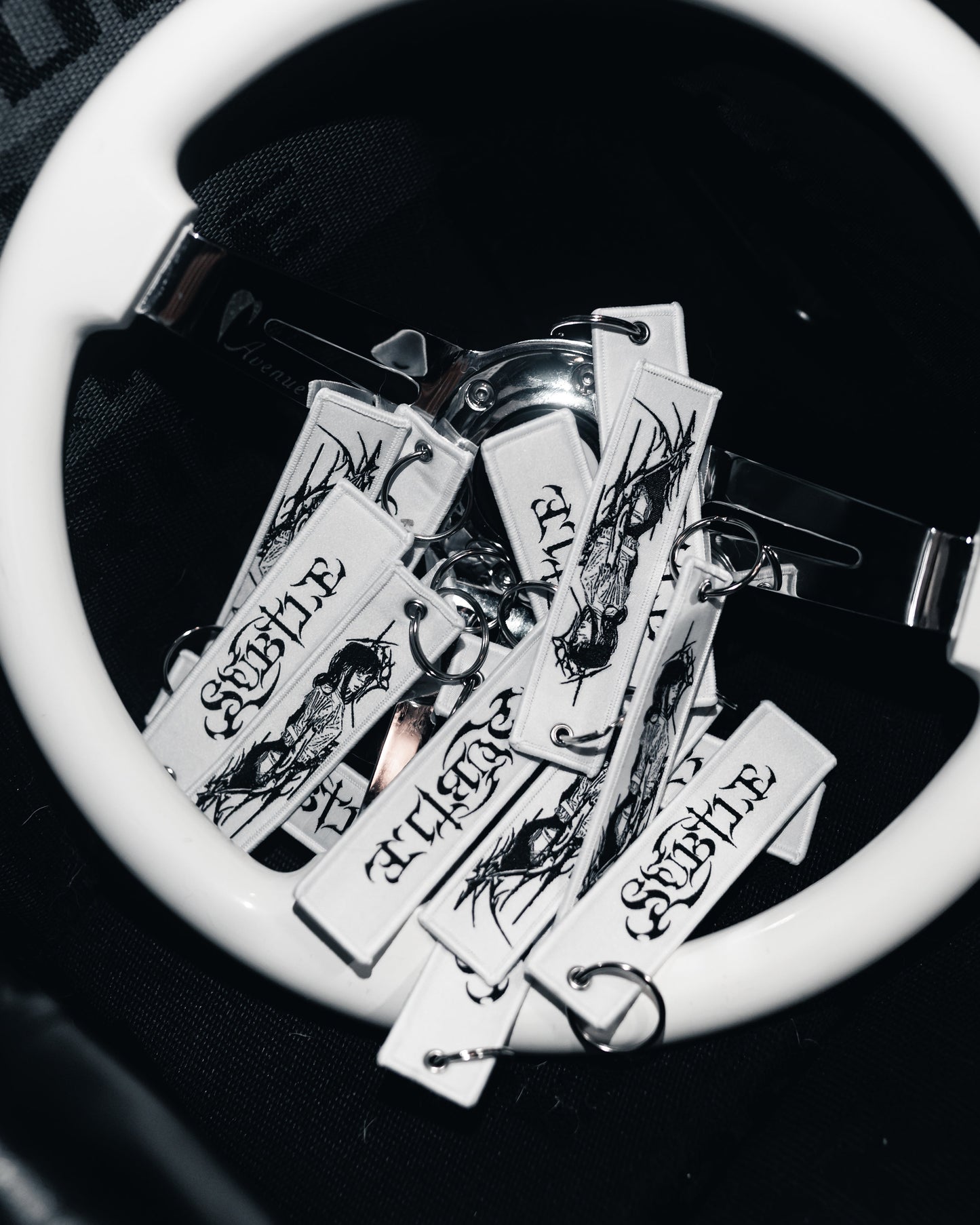 Collection of tattoo-style keychains on a white surface